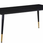 Artized black dining table on steel legs with gold elements
