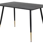 Artized dining table in intense black on steel legs with gold elements
