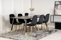 Artized black dining table on steel legs with gold elements